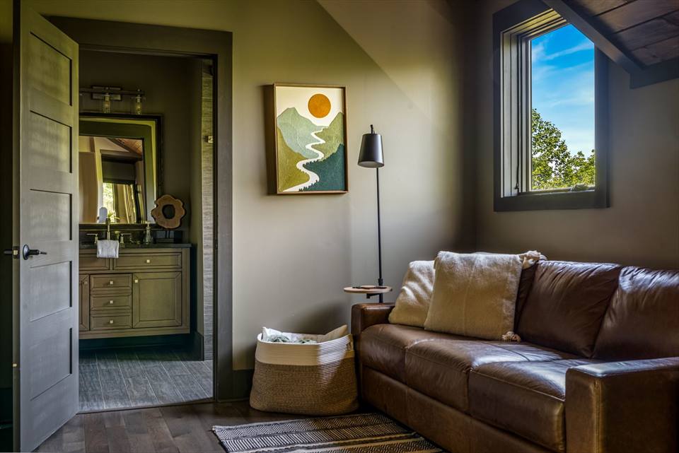 Upstairs gallery sitting area with a leather sleeper sofa