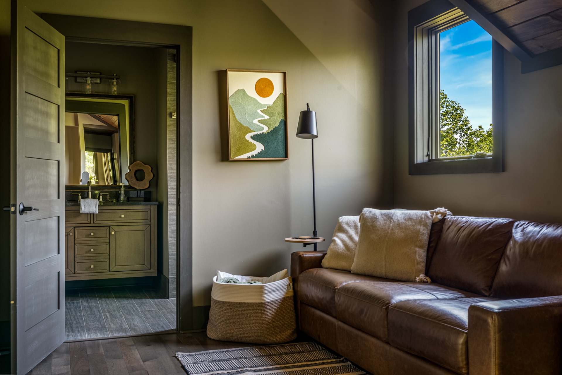 Upstairs gallery sitting area with a leather sleeper sofa
