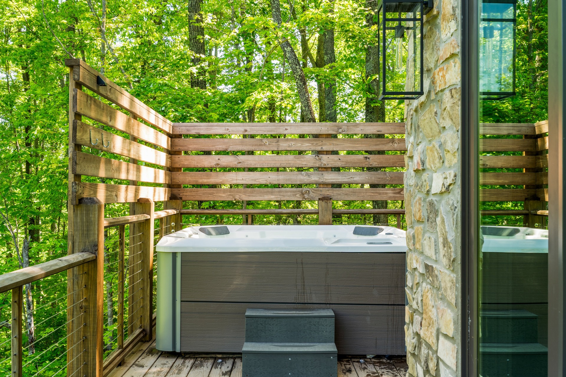 Private hot tub on its secluded deck during the day