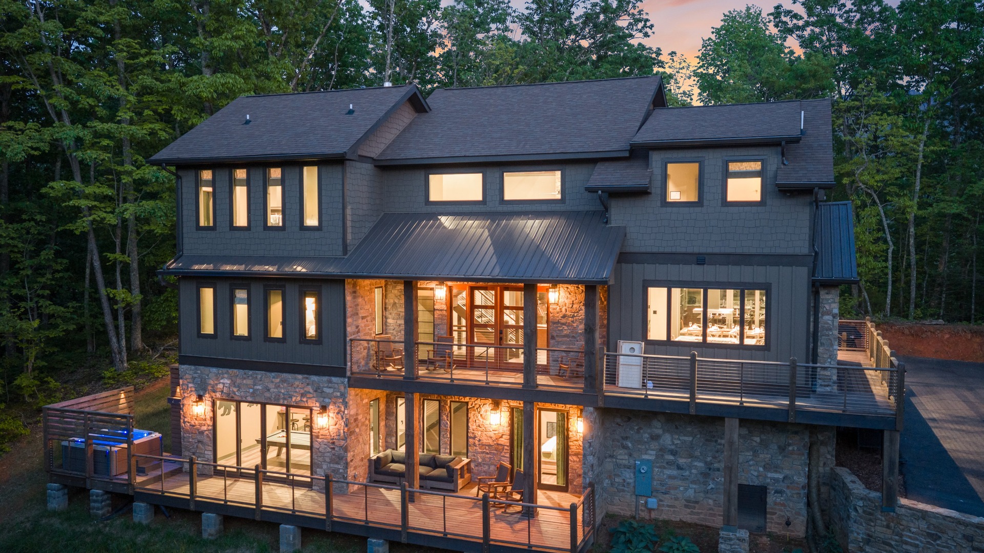 Bougie Bear Chalet illuminated at twilight among the trees