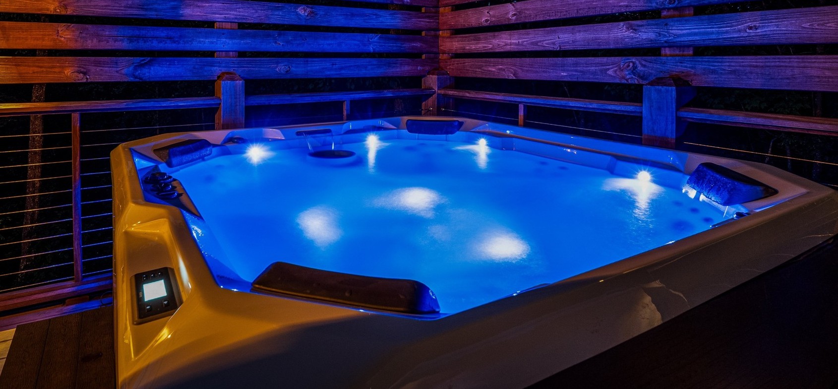 Private 7-seat hot tub glowing beneath the night sky